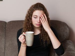 Unhappy woman drinking coffee