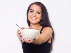Woman smiling while holding a bowl