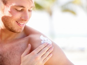 Man putting on sunscreen