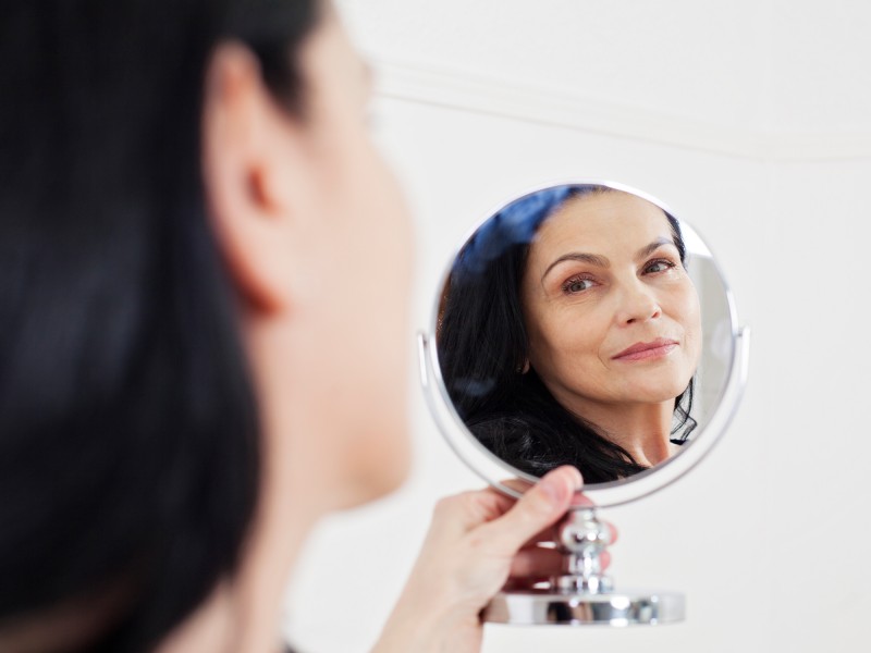 Mature woman looking in the mirror