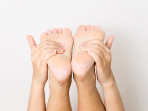 Hands holding feet