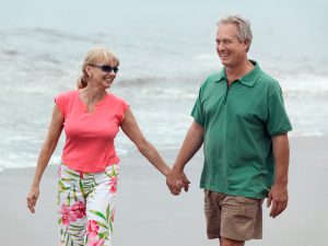Mature couple walking on the beach