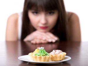 Dieting woman craving for cake