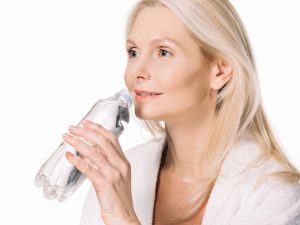 Woman drinking from water bottle