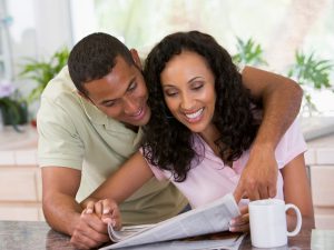 Couple reading newspaper