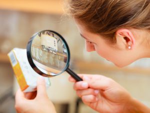 Woman looking at medicine box