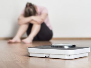 Upset woman and scale