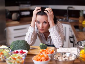 Depressed woman in kitchen