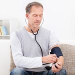 Mature man taking blood pressure