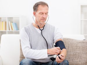 Mature man taking blood pressure