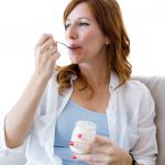 Woman eating yogurt