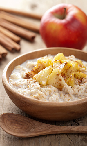 Bowl of oatmeal with apples and cinnamon