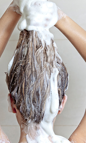 Woman with shampoo in her hair
