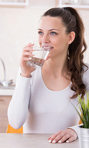 Woman drinking water with ACV