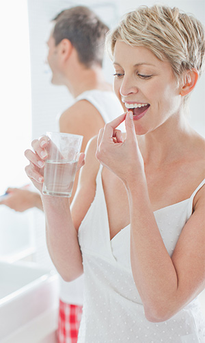 Woman taking oral probiotics