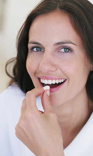 Woman taking nutritional supplements