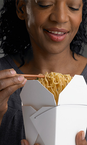 Woman eating Chinese food