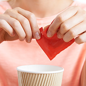 Adding artificial sweetener to coffee