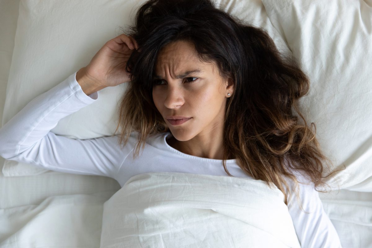 Woman in bed PMS
